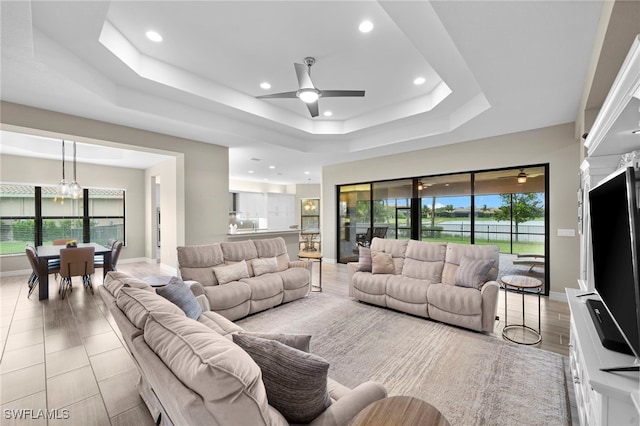 4365 Caldera Cir, Naples, FL 34119 - living room with ceiling fan, healthy amount of natural light, a tray ceiling, recessed lighting, and baseboards