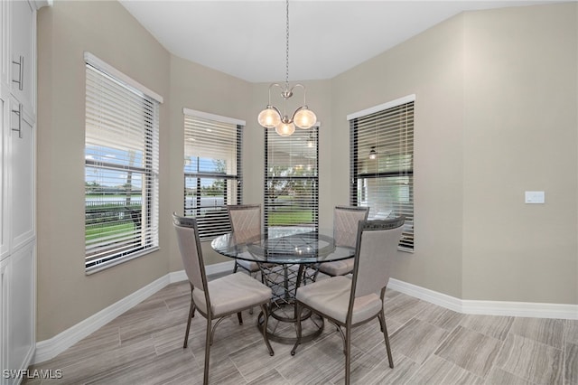 4365 Caldera Cir, Naples, FL 34119 - dining area featuring a chandelier, baseboards, and wood finish floors