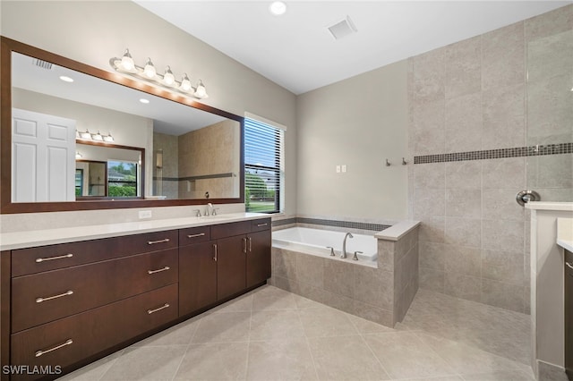 bathroom featuring vanity, separate shower and tub, and tile patterned flooring