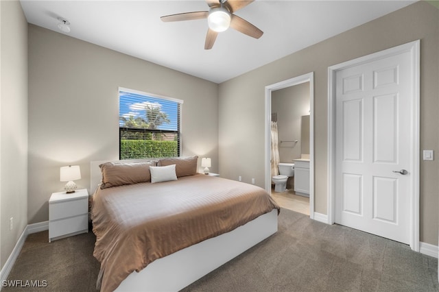 bedroom featuring dark colored carpet, connected bathroom, and ceiling fan