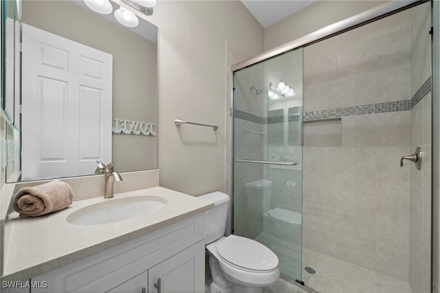 bathroom featuring walk in shower, vanity, and toilet