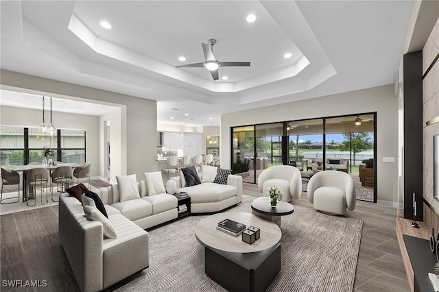 4365 Caldera Cir, Naples, FL 34119 - living room with ceiling fan, a raised ceiling, recessed lighting, baseboards, and a chandelier