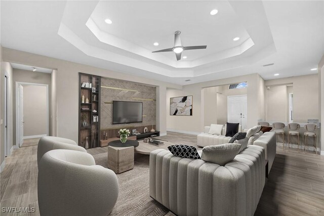 4365 Caldera Cir, Naples, FL 34119 - living room with a tray ceiling, baseboards, recessed lighting, ceiling fan, and wood finished floors