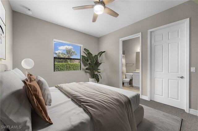 4365 Caldera Cir, Naples, FL 34119 - bedroom with carpet floors, ensuite bathroom, baseboards, and a ceiling fan