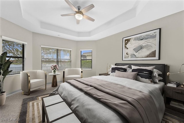 4365 Caldera Cir, Naples, FL 34119 - carpeted bedroom with a raised ceiling, multiple windows, and ceiling fan