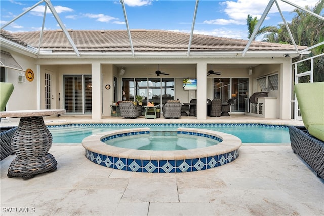 view of swimming pool featuring an in ground hot tub, a patio, ceiling fan, and exterior kitchen