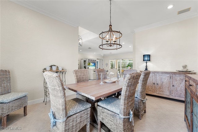 dining area with crown molding, a chandelier, and light tile patterned floors