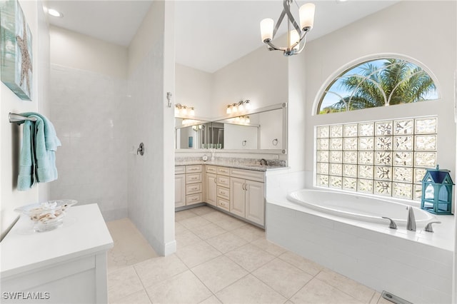 bathroom featuring tile patterned flooring, vanity, a healthy amount of sunlight, and plus walk in shower