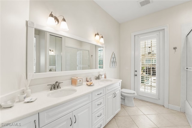 bathroom featuring vanity, an enclosed shower, tile patterned flooring, and a wealth of natural light