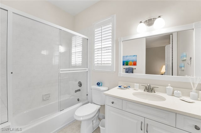 full bathroom featuring vanity, toilet, and combined bath / shower with glass door