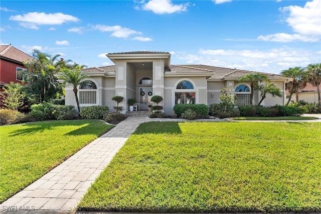 mediterranean / spanish-style home with a front yard