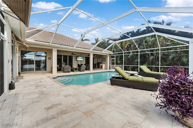 view of swimming pool featuring an outdoor living space, a lanai, ceiling fan, and a patio area