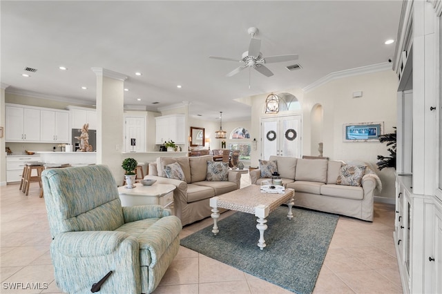 living room featuring light tile patterned flooring, ornamental molding, and ceiling fan