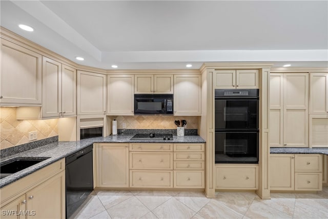 kitchen featuring decorative backsplash, dark stone countertops, light tile patterned flooring, black appliances, and sink