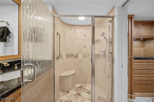 bathroom with vanity and a shower with shower door