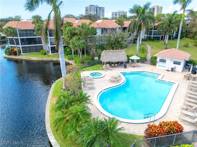 view of pool with a water view, a patio area, a gazebo, and a yard