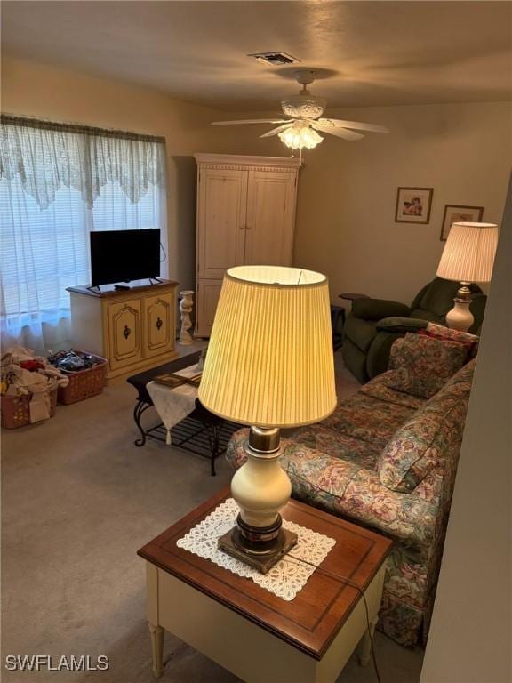 living room with ceiling fan and carpet flooring