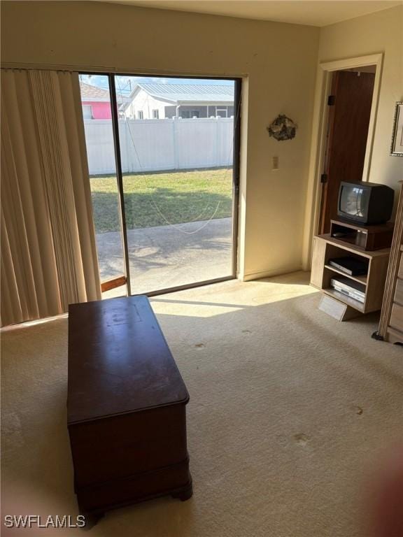 unfurnished living room featuring light colored carpet