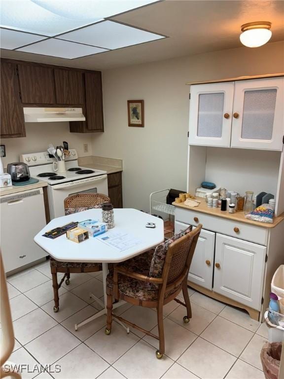 kitchen featuring white appliances, light tile patterned floors, dark brown cabinets, and white cabinets