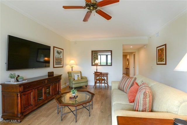 living room with ceiling fan, crown molding, and light hardwood / wood-style floors