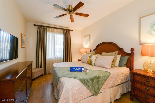 bedroom with ceiling fan and dark hardwood / wood-style floors