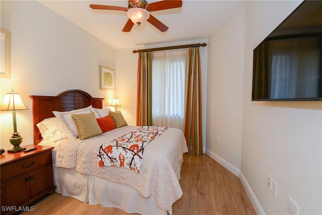 bedroom featuring light wood-type flooring and ceiling fan