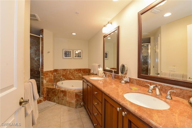 bathroom with tile patterned floors, separate shower and tub, and vanity