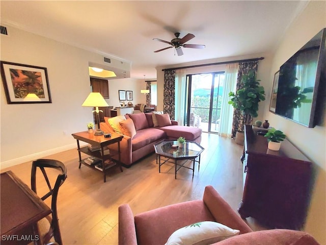 living room with ceiling fan and light wood-type flooring