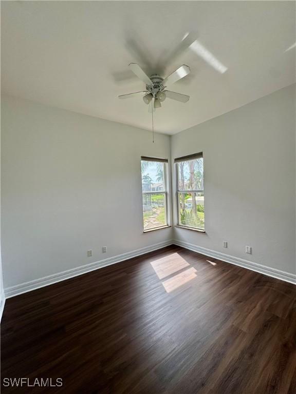 unfurnished room with ceiling fan and dark hardwood / wood-style floors