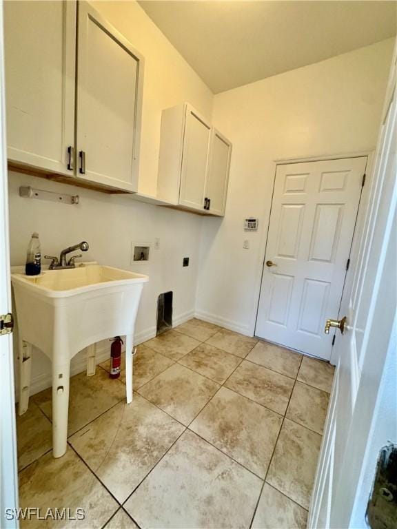 laundry area with light tile patterned flooring, cabinets, and washer hookup