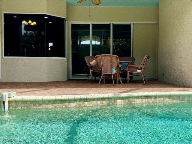 view of swimming pool with ceiling fan