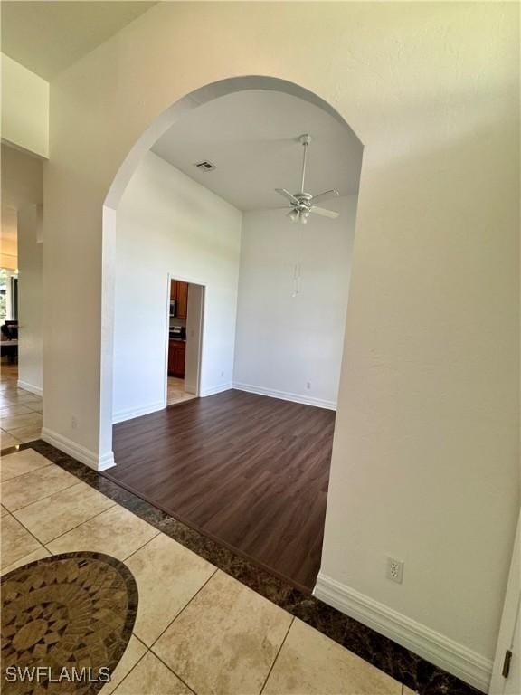 spare room with tile patterned floors and ceiling fan