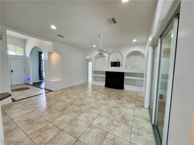 kitchen featuring ceiling fan, built in features, and light tile patterned floors