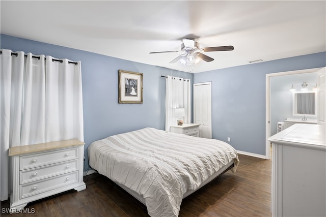 bedroom with dark hardwood / wood-style floors, ensuite bathroom, and ceiling fan