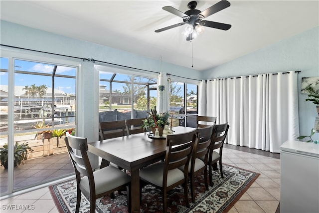 tiled dining room with vaulted ceiling and ceiling fan