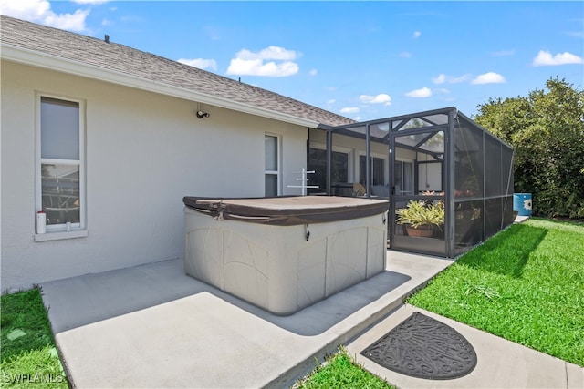 view of patio with a hot tub and glass enclosure