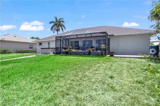 back of property with a patio area, a lanai, and a lawn