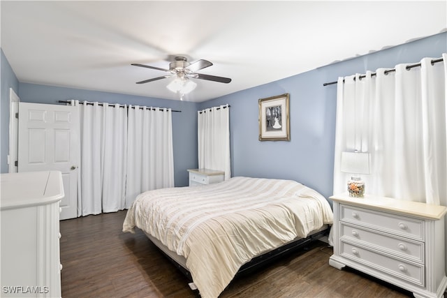 bedroom with dark hardwood / wood-style floors and ceiling fan