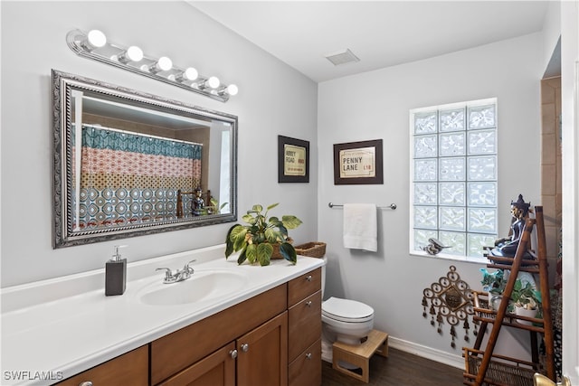 bathroom featuring vanity, a shower with curtain, toilet, and wood-type flooring