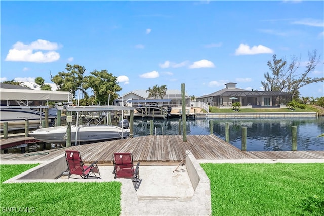 dock area featuring a yard, a water view, and a lanai