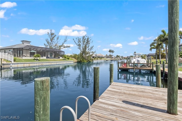 dock area featuring a water view and glass enclosure