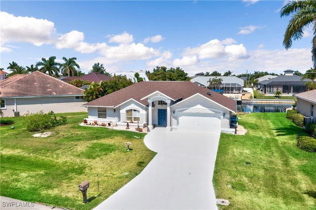 view of front facade featuring a front yard, a garage, and a water view