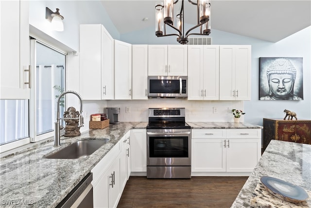 kitchen with stainless steel appliances, sink, vaulted ceiling, white cabinets, and dark hardwood / wood-style flooring