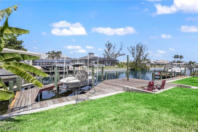 dock area with a lawn and a water view