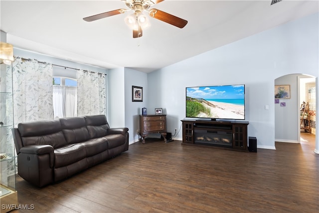 living room with lofted ceiling, dark wood-type flooring, and ceiling fan