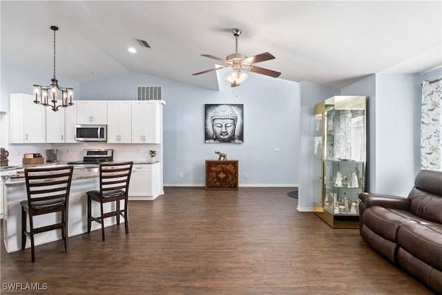 kitchen featuring dark hardwood / wood-style floors, appliances with stainless steel finishes, pendant lighting, and white cabinetry