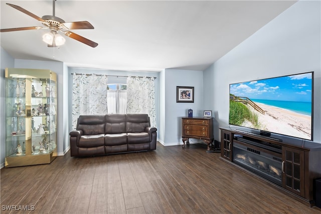 living room featuring ceiling fan and dark hardwood / wood-style flooring