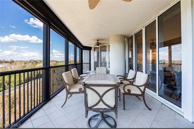 sunroom featuring a healthy amount of sunlight and ceiling fan