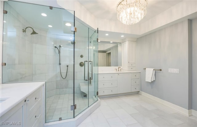 bathroom featuring vanity, a notable chandelier, and walk in shower