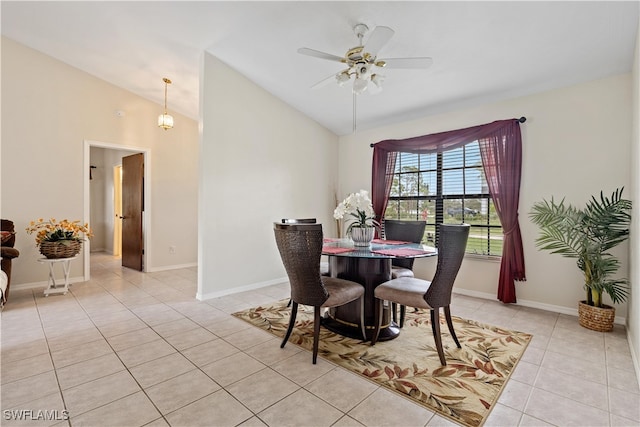 tiled dining area with ceiling fan and vaulted ceiling